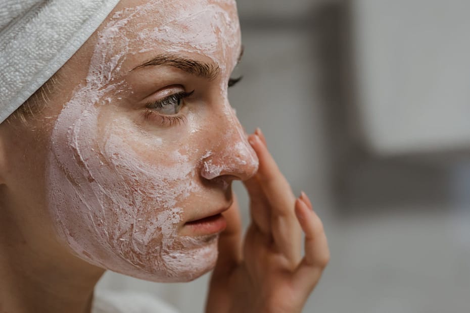 close up photo of a woman applying facial cream